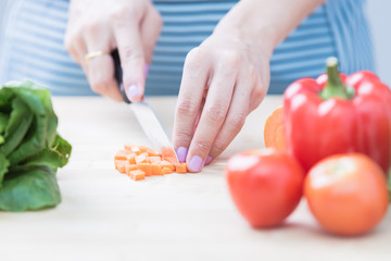 Salad preparation - cutting fresh vegetables into pieces