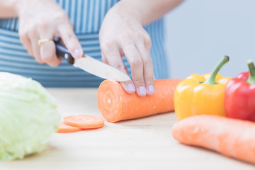 Obraz na płótnie Canvas Salad preparation - cutting fresh vegetables into pieces