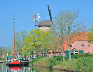Windmühle und Fehnschiff am Fehnkanal an der Fehnroute in Ostfriesland bei...
