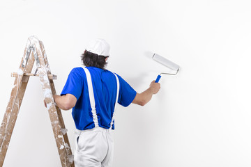 Painter man at work climbing a vintage wooden ladder and paintin © guerrieroale