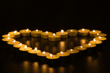 ea lights in the shape of a heart on wood background