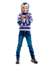 Cute little girl in a warm sweater and  cap