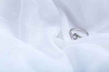 Diamond ring on a white cloth, close up