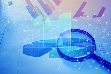 Magnifying glass and documents with analytics data lying on tabl