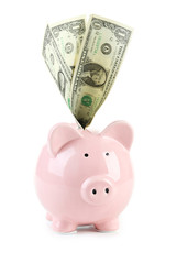 Pink piggy bank with dollars isolated on a white