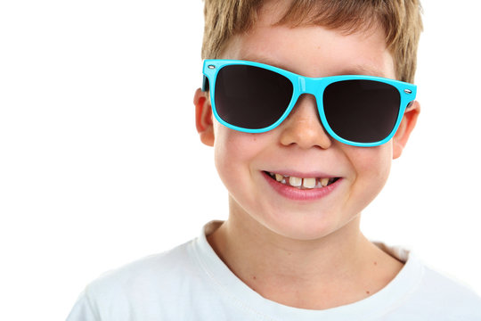 Portrait of happy little boy with sunglasses on white background