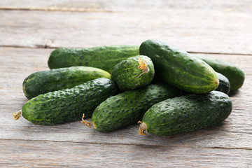 Fresh cucumbers on grey wooden background