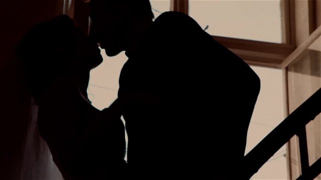 Kissing young couple, silhouette