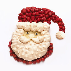 Father Christmas shaped from meringue and strawberries.