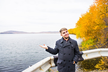 Fototapeta premium Men in autumn park near the lake
