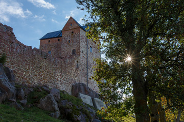Old castle with tree and sun on Aland Islands, Finland, Kastelholm Castle