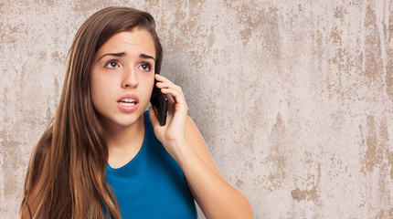 young pretty woman worried talking on mobile phone
