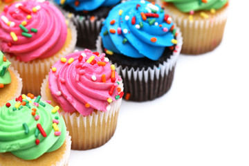 Multicolored Cupcakes Isolated on a White Background