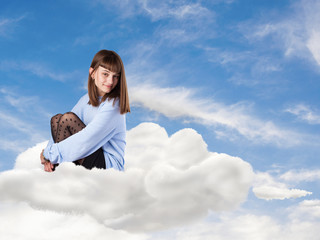 young pretty woman sitting on a cloud