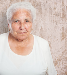 adorable old woman face closeup over abstract background