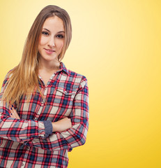 Portrait of young woman standing with arms crossed