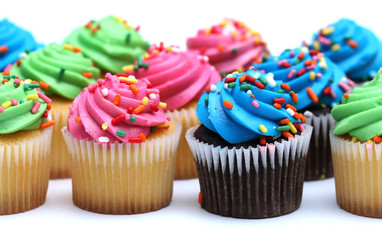Multicolored Cupcakes Isolated on a White Background