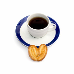 cup of coffee on a saucer and one cookies in front, the isolated