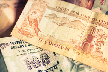 Selective focus on currencies of United Arab Emirates and India