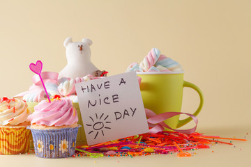 Party decoration. Cupcake with mug and message have a nice day
