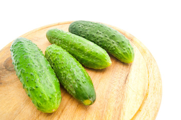 four cucumbers on cutting board
