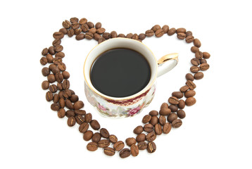 Heart of coffee beans and cup of coffee