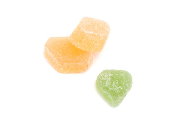 three fruit candies on white
