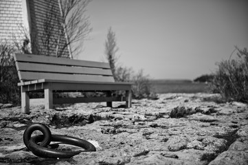 Close up of an anchor with a bench in background,  Georgian Bay, Bruce peninsula, Ontario, Canada	