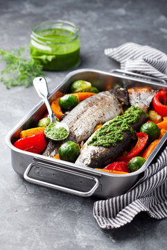 Baked trout with vegetables and dill pesto, selective focus