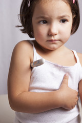 Little girl with electronic thermometer