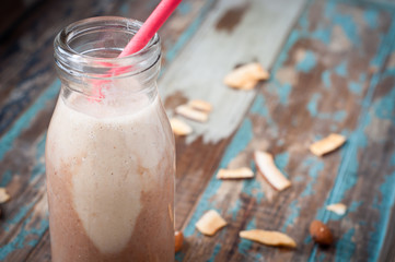 Healthy chocolate flavor smoothie milkshake made from blended cacau,almonds with yoghurt swirl. Served in a milk bottle style glass.