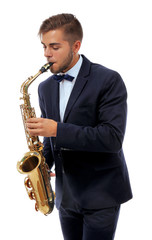 Fototapeta premium Elegant happy saxophonist plays music on sax on white background