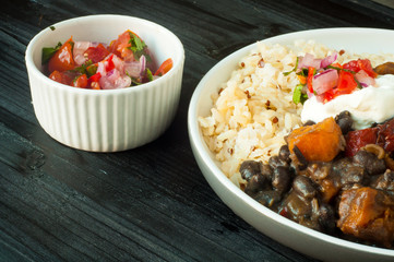 Vegetable feijoada. A vegetarian version of the popular Brazilian dish made with black beans, butternut squash and served with rice and salsa.