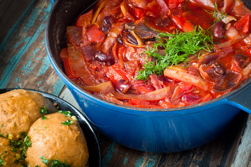 Traditional Ukrainian beetroot broth, known as Borshch, served with Pampushky garlic bread on a...
