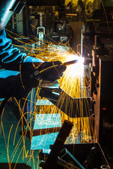 sparks while welder uses torch to welding