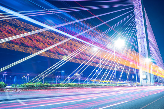 long exposure car light tracks with bridge background © victor217