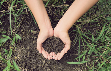 Soil- handful,female hands, humus soil