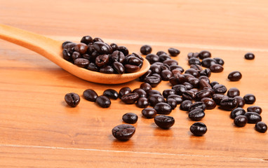 Fototapeta na wymiar Coffee beans on wooden background