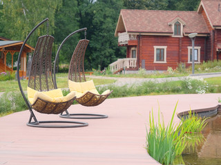 The image of chaise-longues around the pond outside