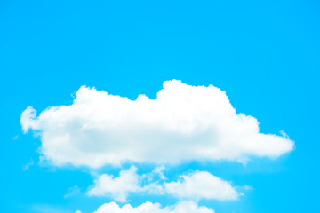 White puffy clouds on summer blue sky background