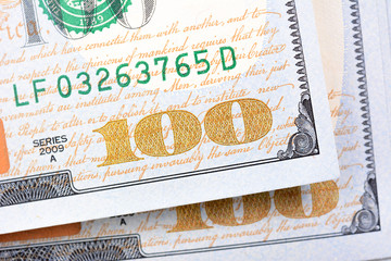 Close up of number one hundred (100) on US dollar money