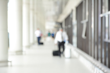 Fototapeta premium Blur image of people (travelers) walking in airport hallway