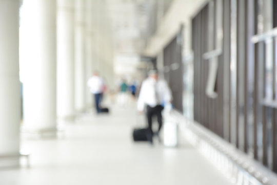 Blur image of people (travelers) walking in airport hallway