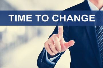 Businessman hand touching TIME TO CHANGE message  on virtual screen