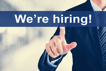 Businessman hand touching We're hiring! message on virtual screen