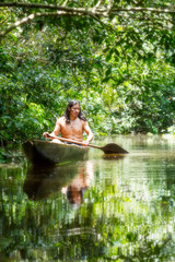 amazon rainforest ecuador indigens mature male on symbolic wooden canoe sliced from a single tree cruising gloomy waters of ecuadorian amazonian first forestry amazon rainforest ecuador raft excursio