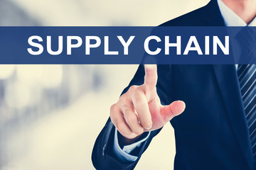 Businessman hand touching SUPPLY CHAIN sign on virtual screen