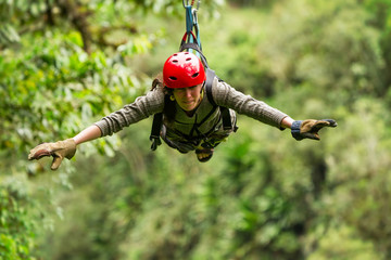 A woman hangs suspended on a wire, gliding through the Ecuadorian rainforest on a thrilling zipline...