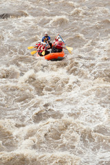 Fototapeta na wymiar Experience the thrill of whitewater river rafting in Ecuador with a diverse group of men and women,guided by a professional pilot.