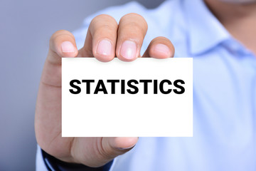 STATISTICS word on the card held by a man hand